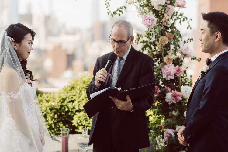 Public Hotel NYC spring rooftop wedding with Stella and Peter. NYC began to loosen COVID restrictions so events and weddings were finally allowed. Stella and Peter were able to keep their original wedding date, but unfortunately Stella's parents couldn't make it to the wedding due to COVID travel restrictions. Stella and Peter's wedding took place on 17th floor with rooftop access at the Public Hotel. Their wedding ceremony was on the rooftop, as well as their first look and some photos then we wandered around the hotel and took some epic photos at the pent house and escalator. Public Hotel NYC was so fun to photograph and I had the coolest, the most chill couple to work with. Stella and Peter's epic wedding at Public Hotel NYC photographed by Karis | Hey Karis.